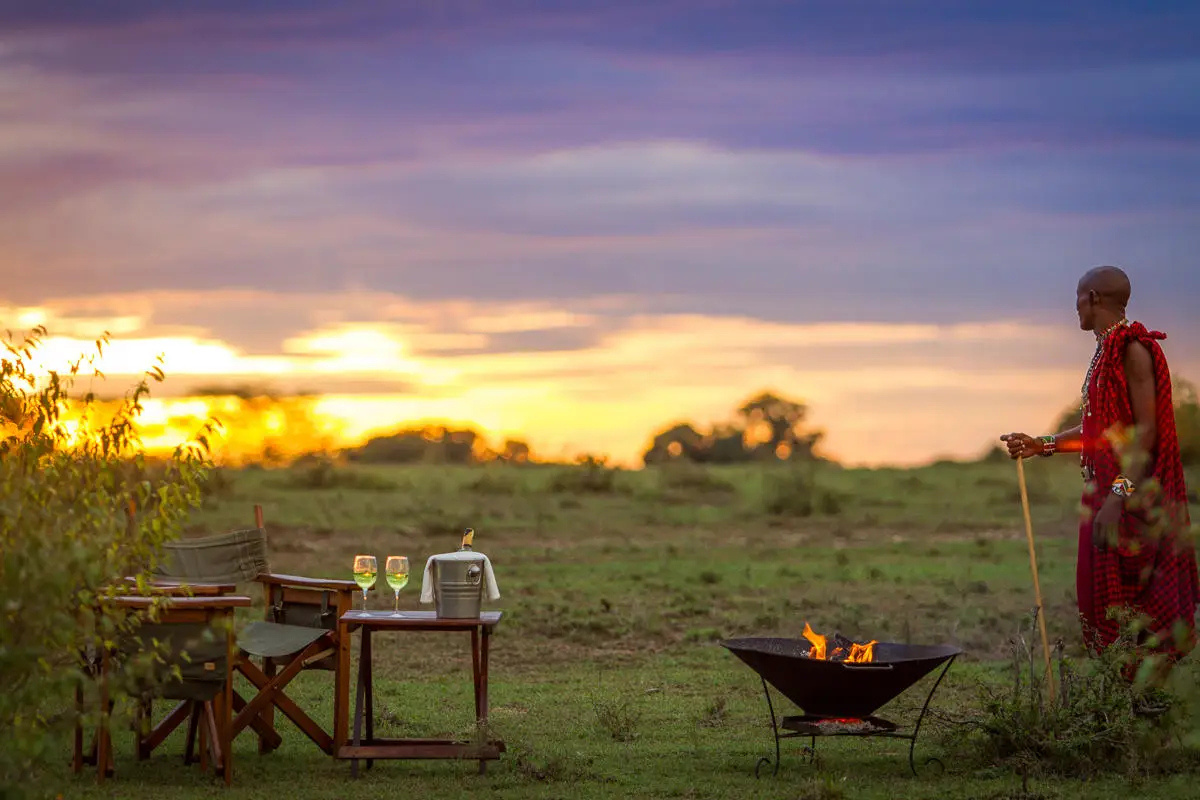 A sundowner scene in Kenya at golden hour.