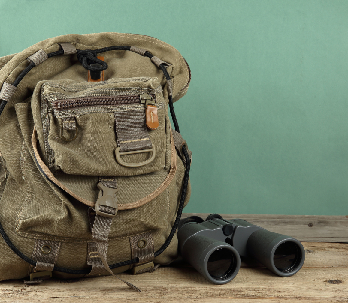 A safari backpack with binoculars.
