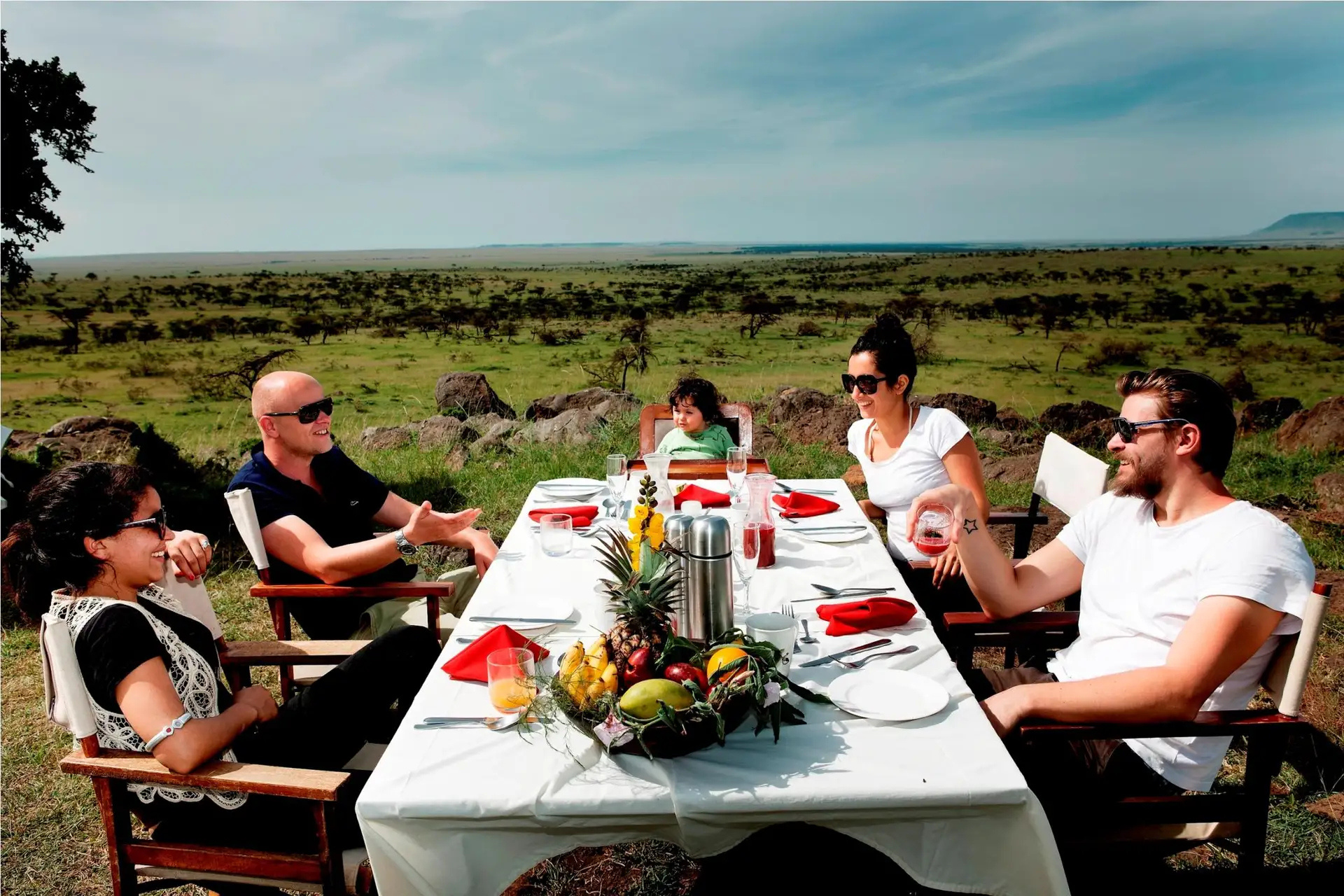 A family on safari, breakfast in the bush.