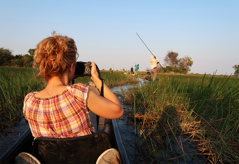 Guests on a mokoro safari in the Okavango Delta